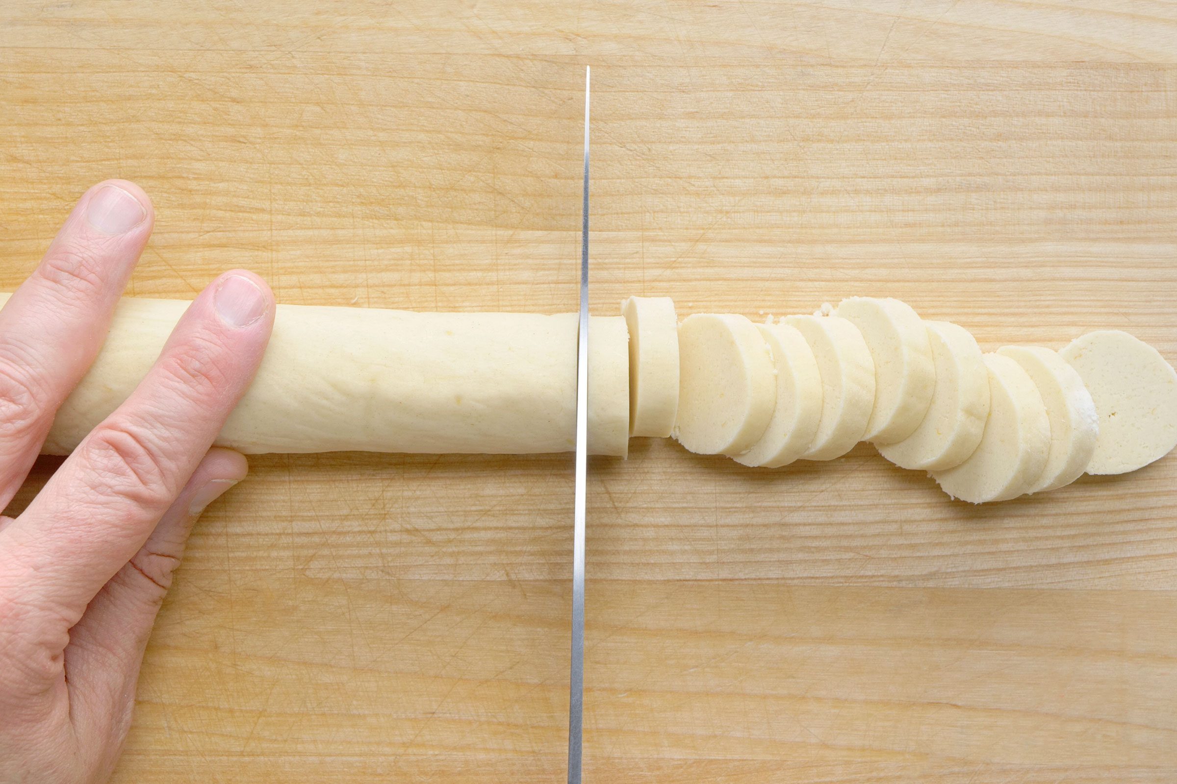 Chilled cookie dough logs sliced into 1/4-inch-thick slices