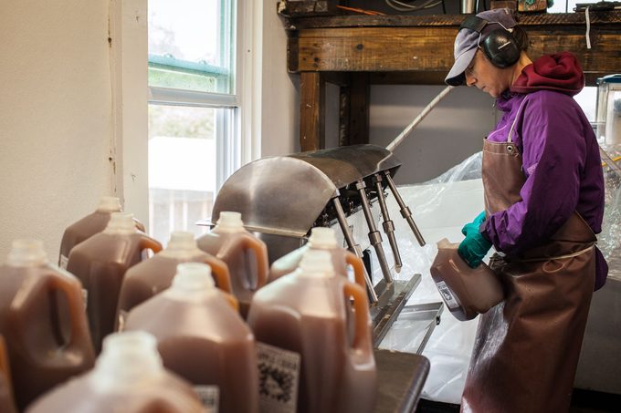 Farmhand Sara Winters bottles apple cider at Clarkdale Fruit Farms on September 30, 2015 in Deerfield, Massachusetts.