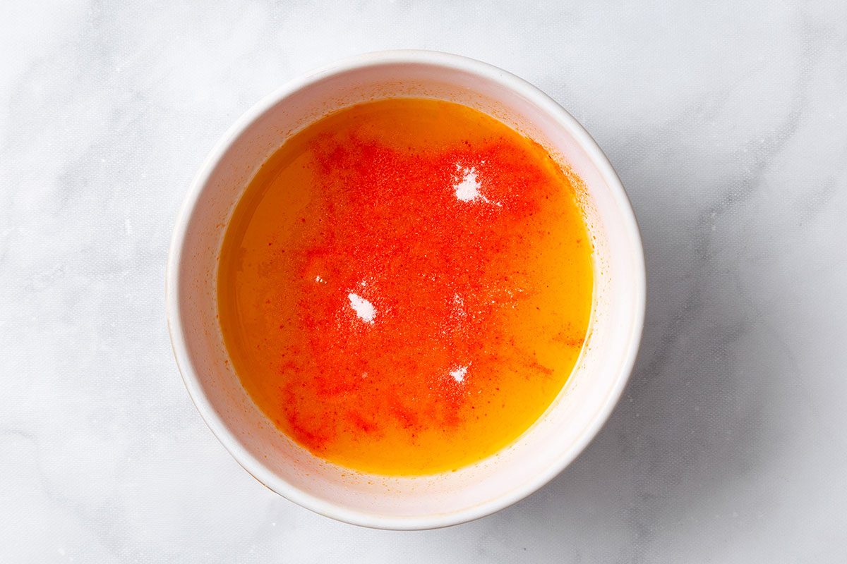 Heated apricot nectar with sprinkle orange gelatin on top for step one of Apricot Delight for Taste of Home