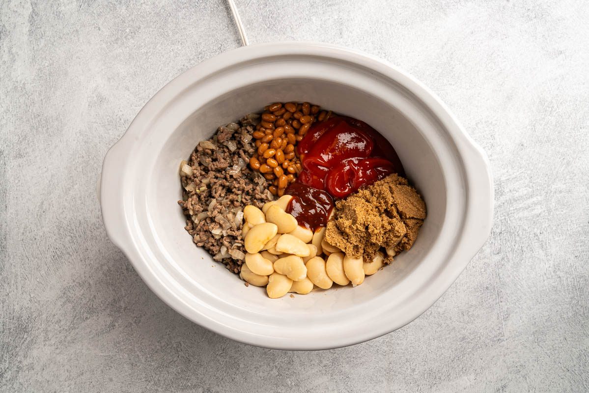 all the ingredients added to the slow cooker.