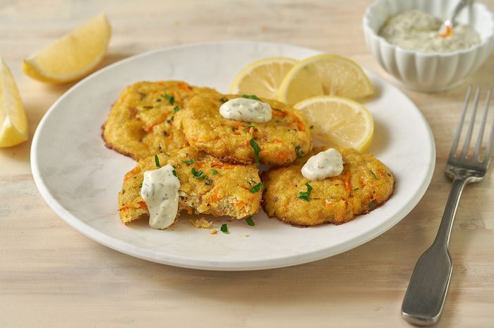 Close-up horizontal shot of the Taste of Home Baked Crab Cakes, highlighting the golden crust and tender crabmeat inside each cake.