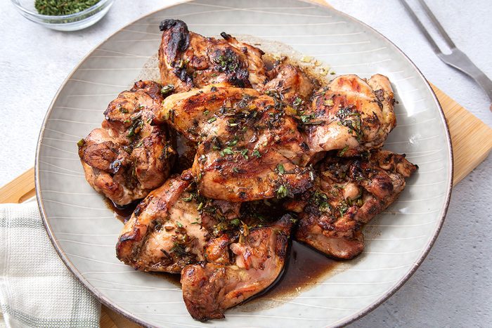 Balsamic Chicken on a serving platter topped with chopped parsley or Taste of Home