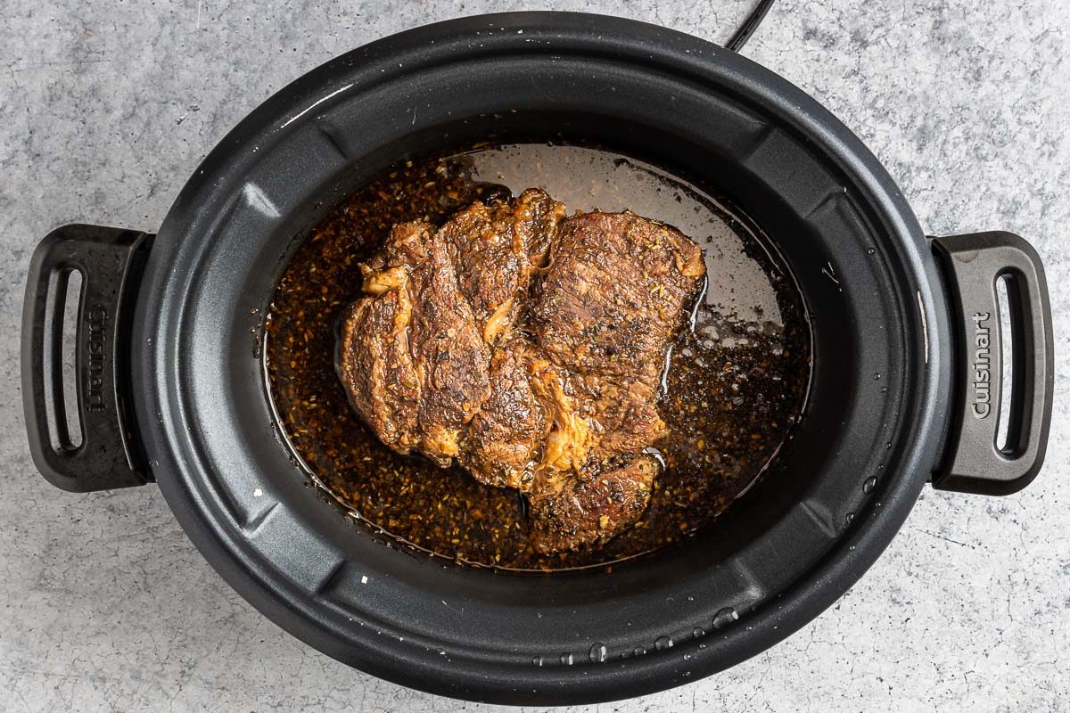 Taste of Home Beef with Polenta photo of the braised beef in a crock pot.