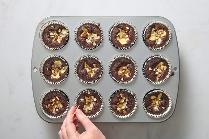 Testing the baked cupcakes with a toothpick