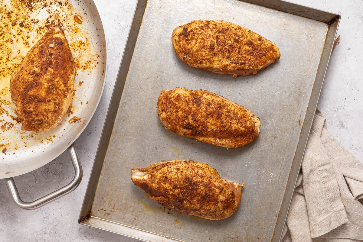 Baking Sheet And Pan With Cooked Chicken Breasts
