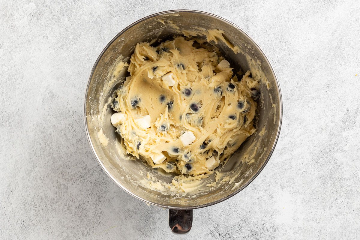 Taste of Home Blueberry Cheese Cake photo of folding in the blueberries and frozen cream cheese cubes.