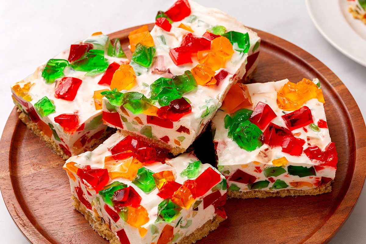 Slices of Broken Glass Jello of a wooden serving platter for Broken Glass Jello recipe for Taste of Home