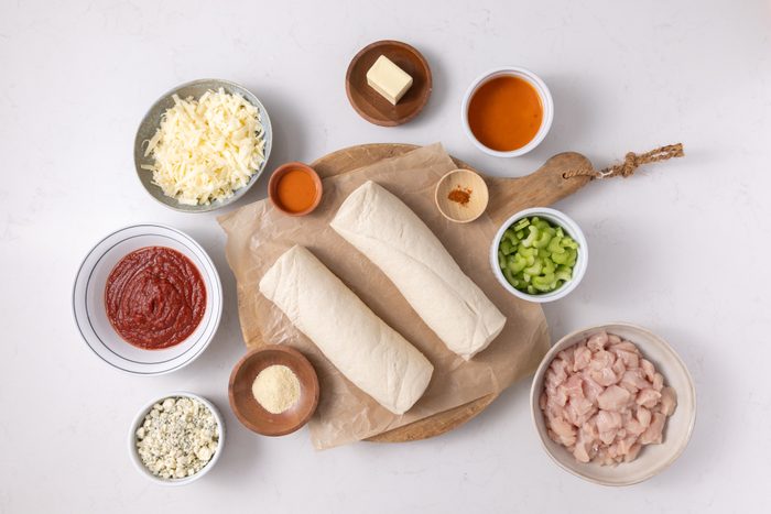 Ingredients for buffalo chicken calzone on kicthen counter.