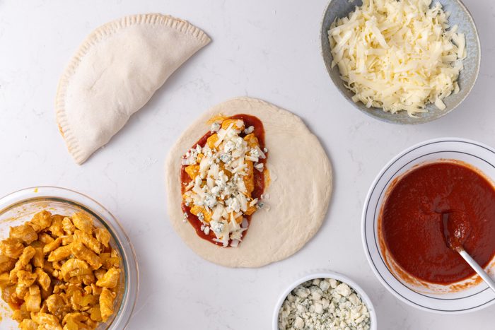 Buffalo chicken calzones being assembled.