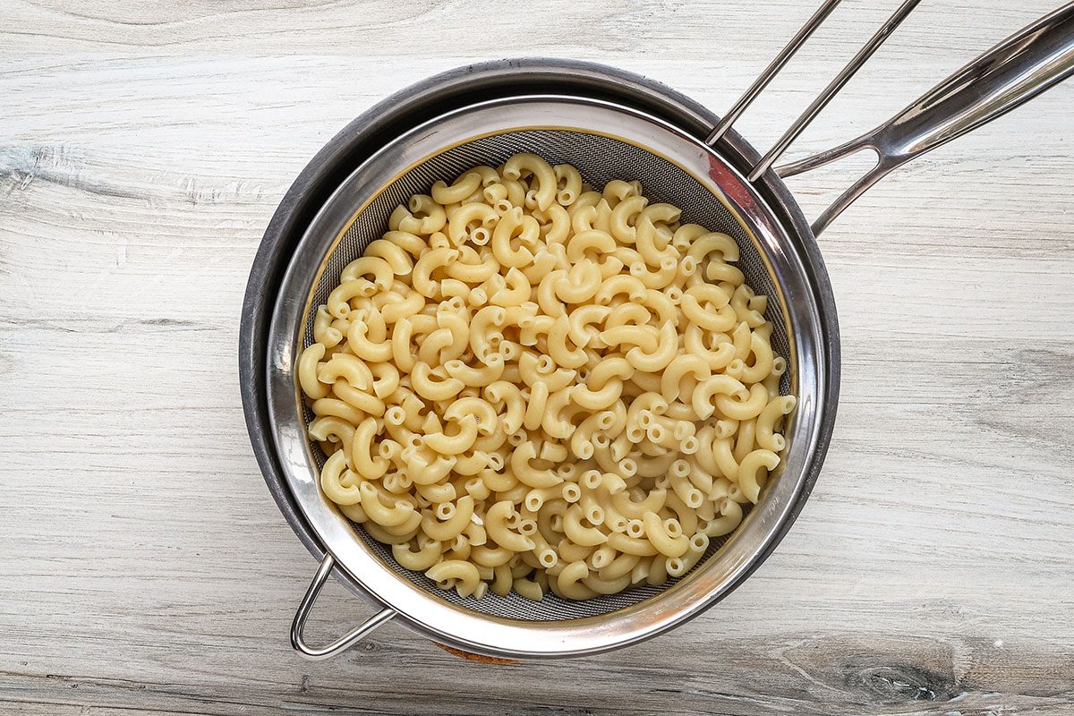 Draining the macaroni for Buffalo chicken mac and cheese.
