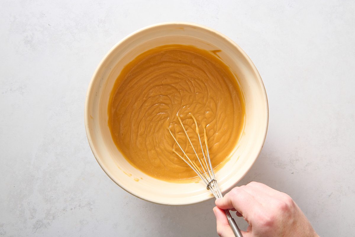 Whisking the butterscotch pudding in a large bowl