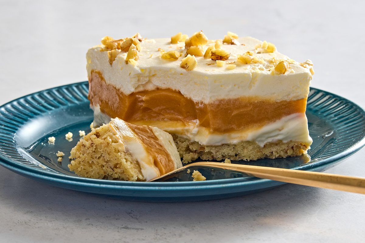 Closeup shot of a slice of butterscotch delight with a forkful removed