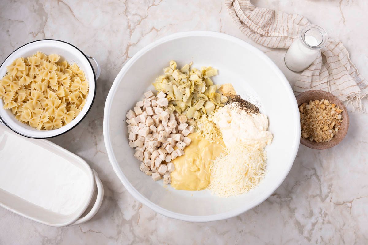 large bowl, combine the chicken, artichokes, soup, Parmesan, mayonnaise, garlic, onion powder and pepper overhead