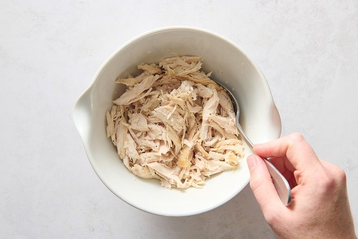 Combining the chicken with lime juice and seasoning
