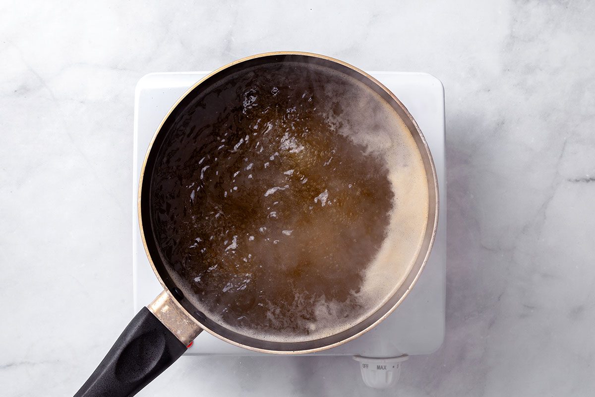 Chicken broth and water simmering in a saucepan for Chicken Risotto recipe for Taste of Home