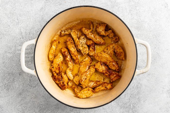 browning the chicken in a Dutch oven.