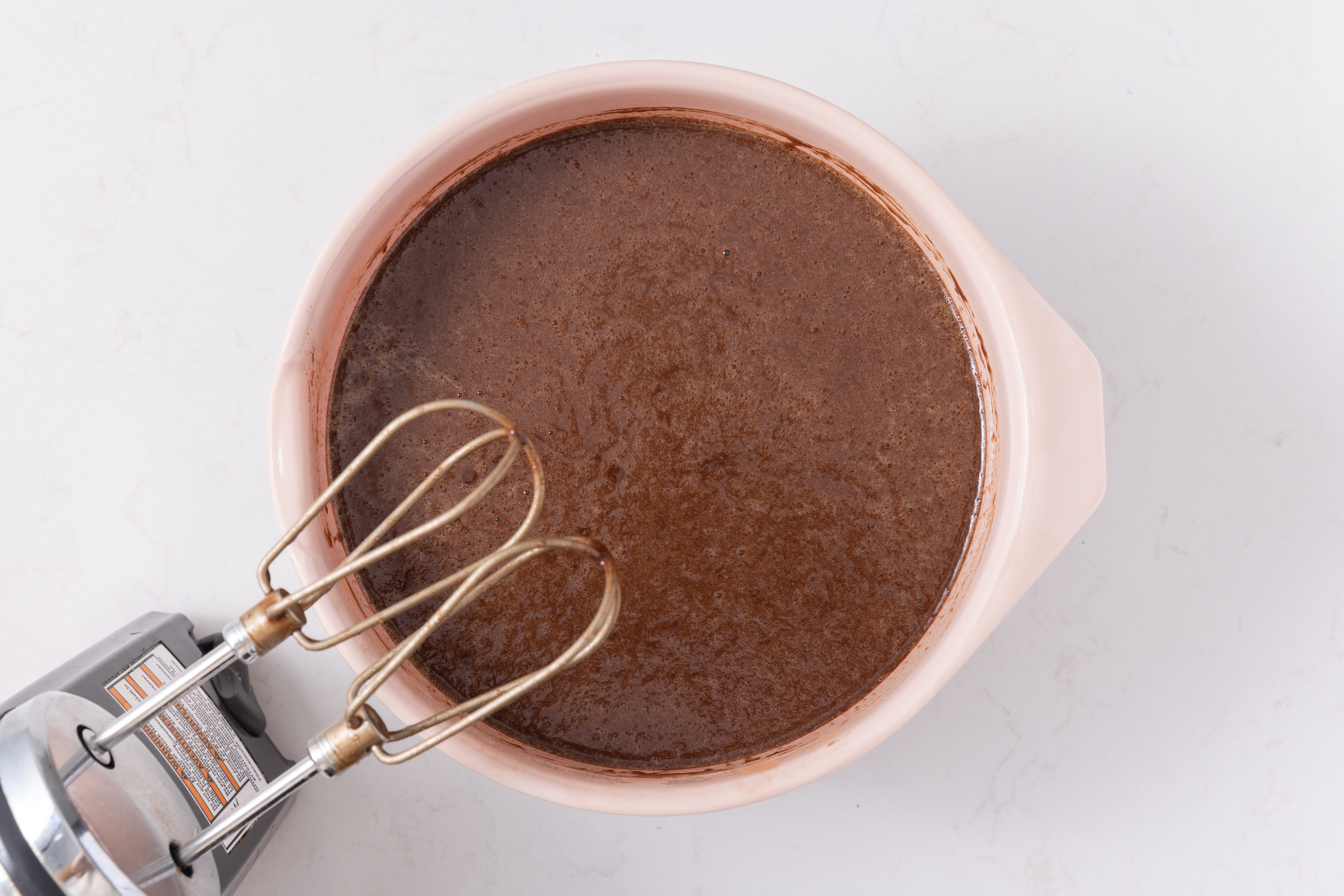 Wet ingredients for cake base being mixed together.
