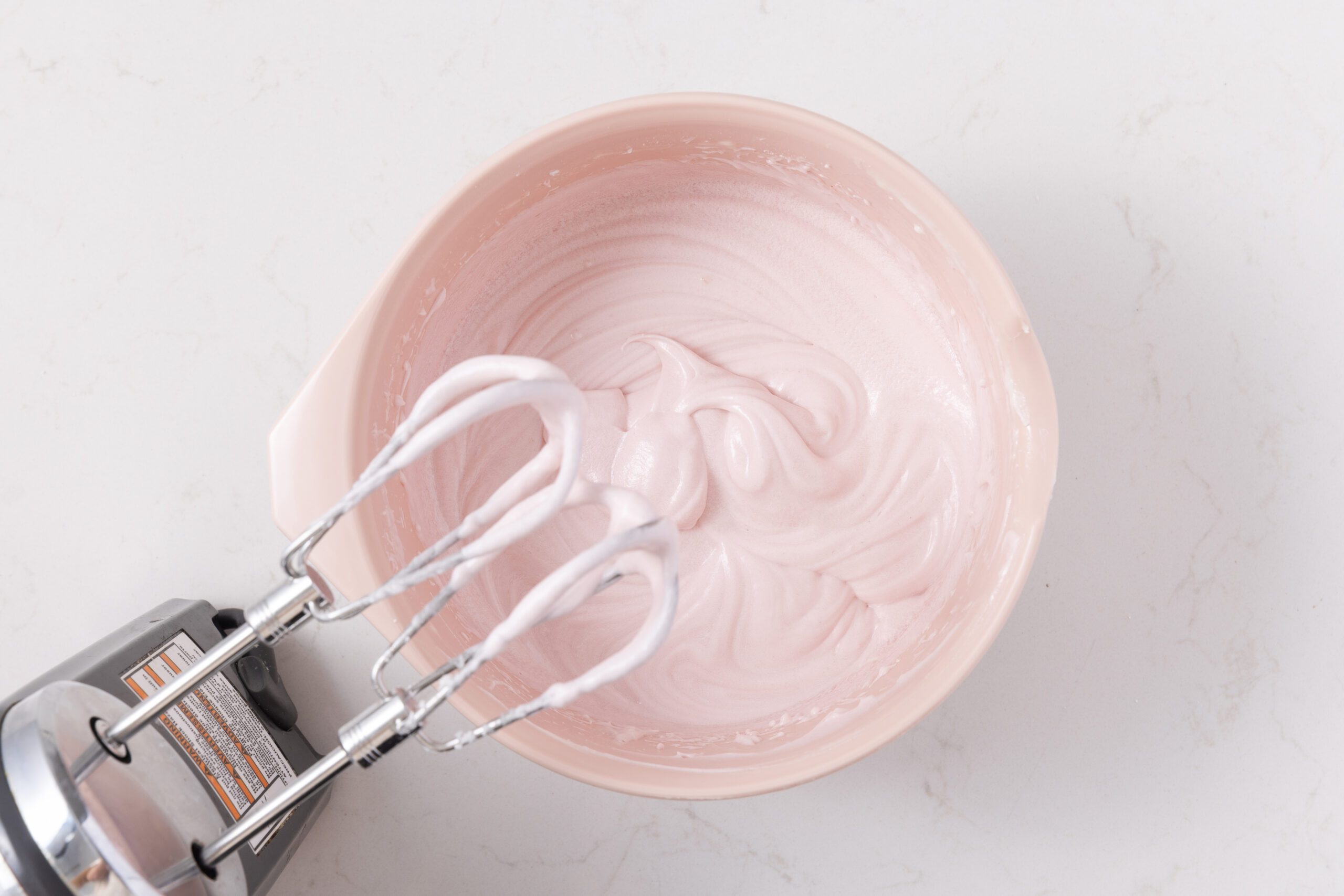 Cake filling being mixed in mixing bowl.