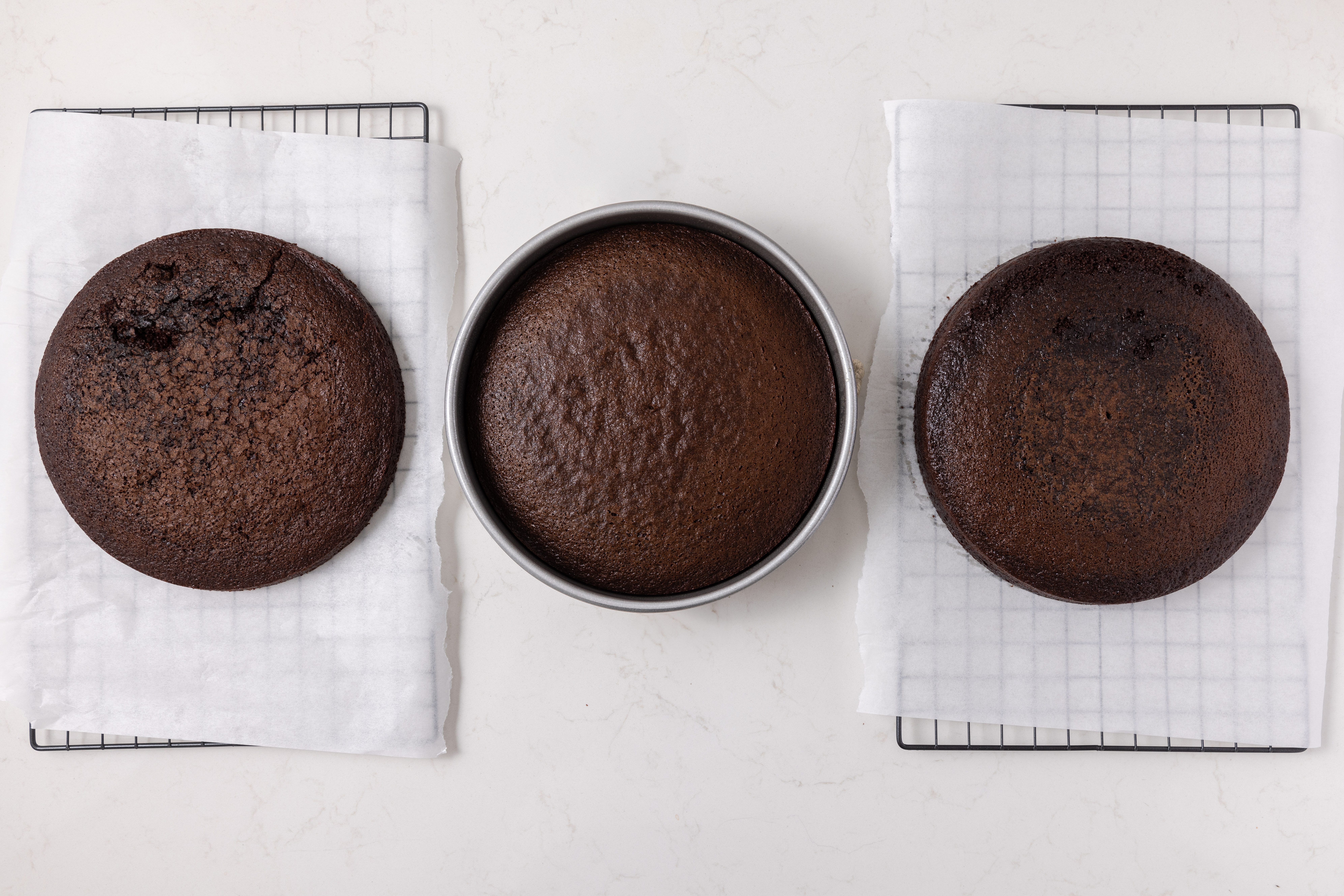Chocolate raspberry cake base baked, cooling on wire racks.
