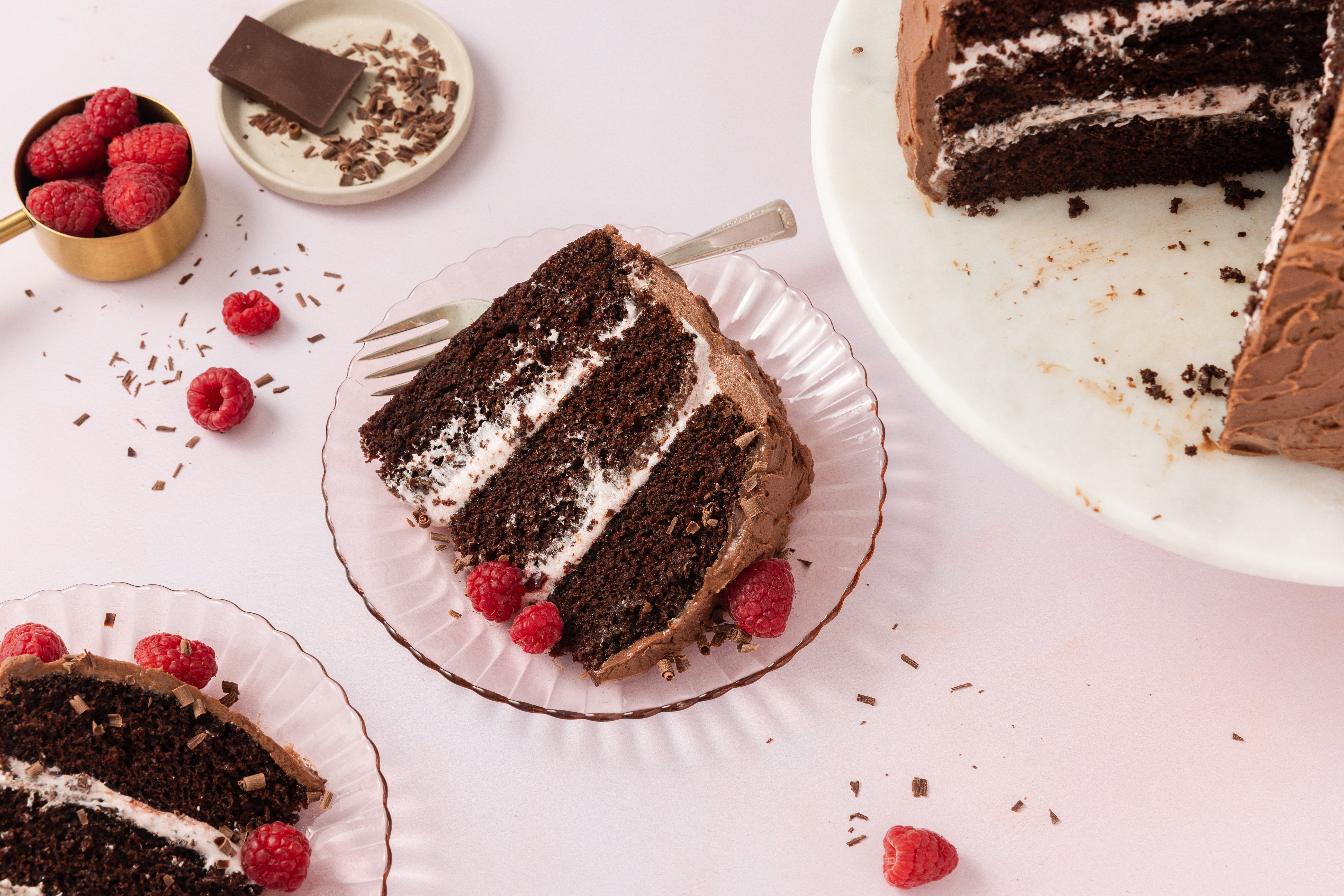 Chocolate raspberry cake sliced and served on plates.