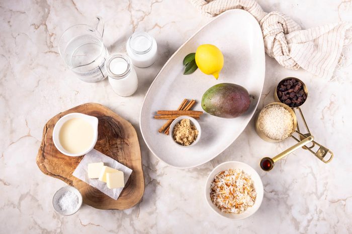 Ingredients for Coconut Rice Pudding overhead on marble