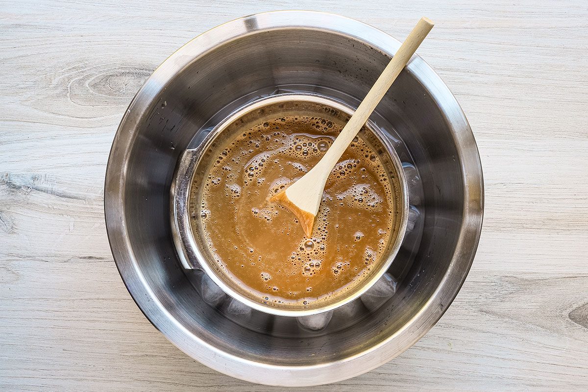 Coffee ice cream mixture is in a bowl of ice water, cooling before it goes into the fridge.