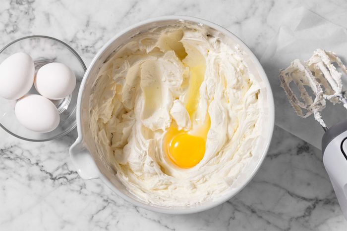 In a large bowl, beat cream cheese until smooth. Beat in eggs, one at a time, until combined.