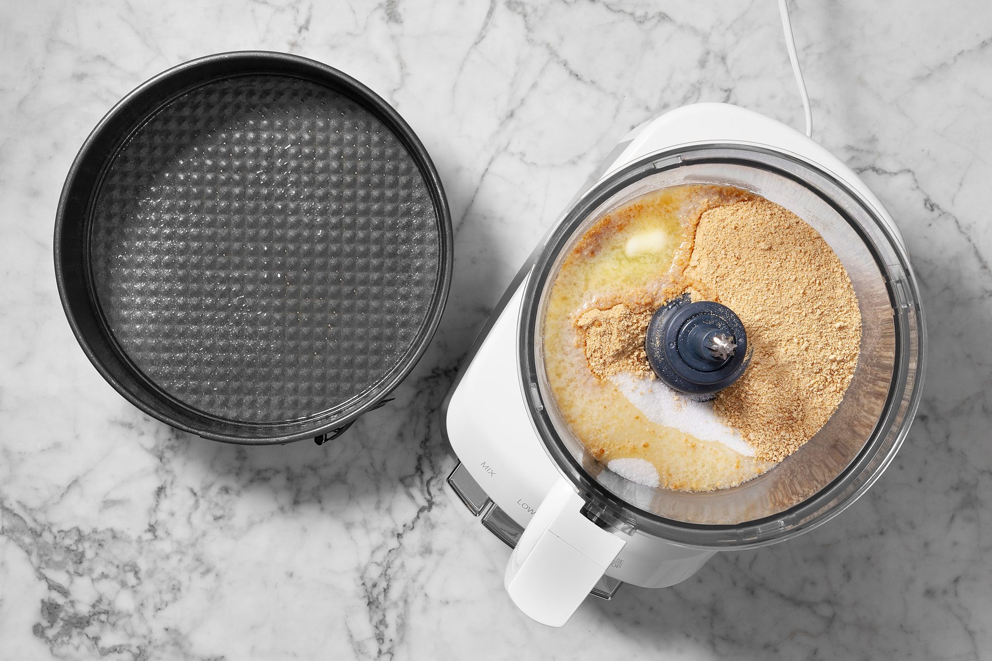 In a small food processor, combine the graham cracker crumbs, melted butter and sugar.