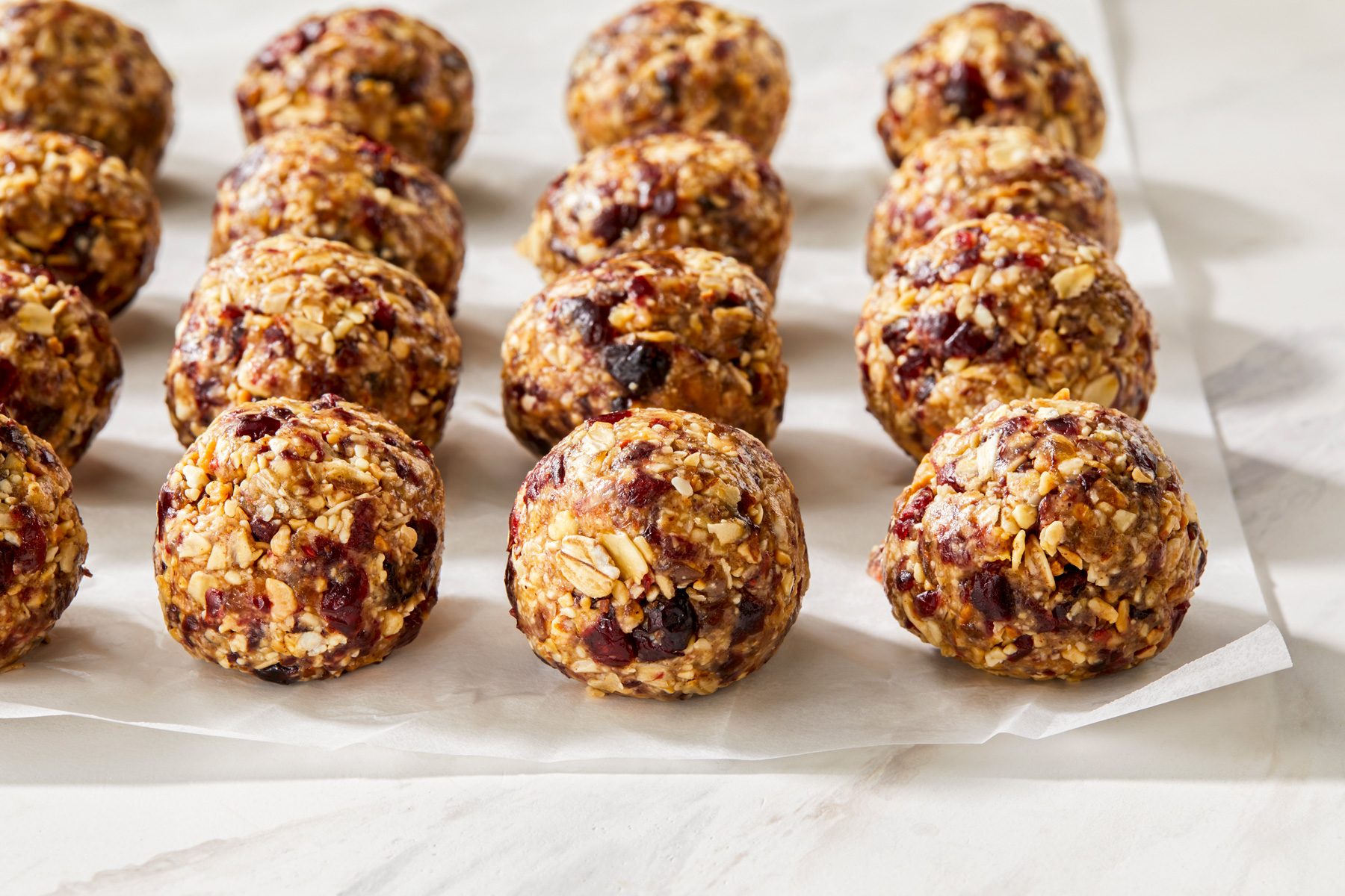 A wide shot of almond energy balls, arranged neatly.