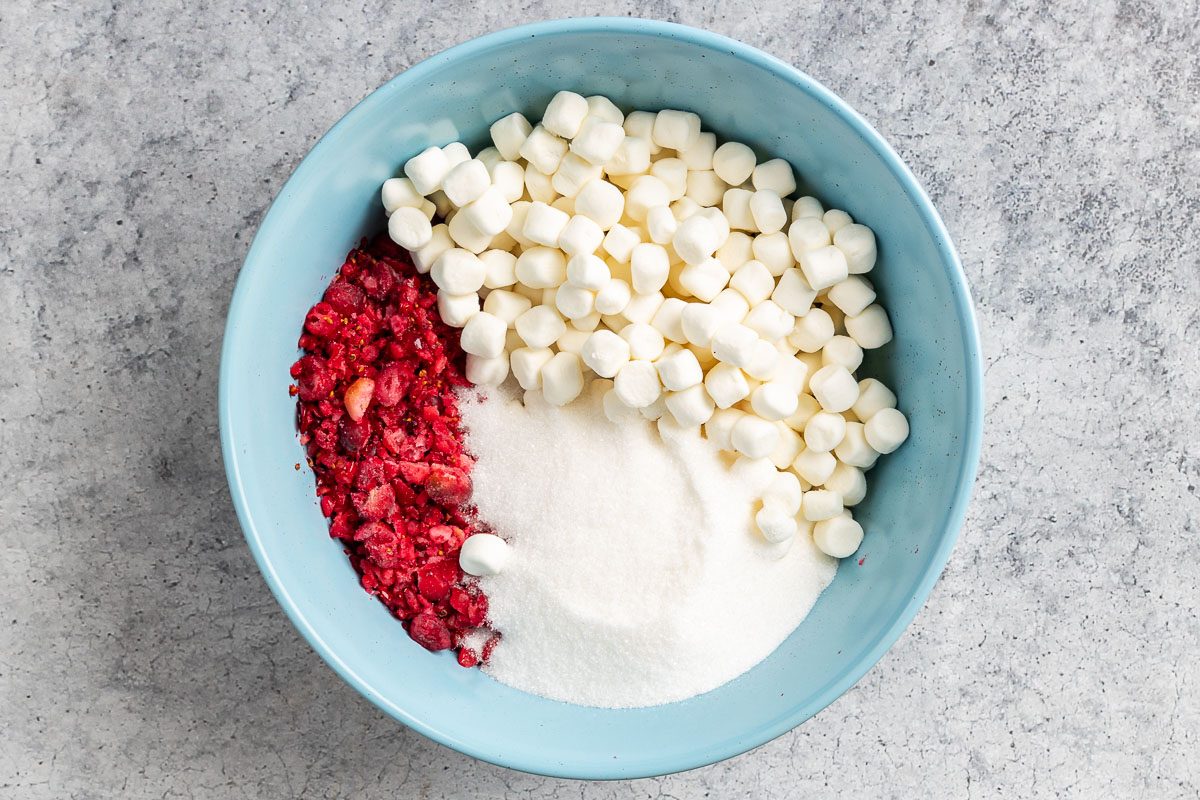 cranberries, marshmallows, and sugar in a bowl.