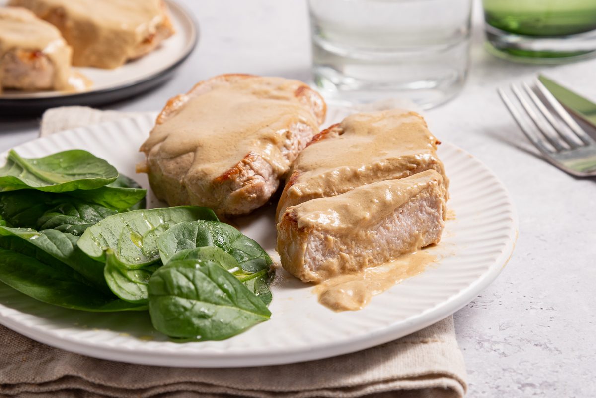 Plate With Cream Cheese Pork Tenderloin Chops And Green Salad