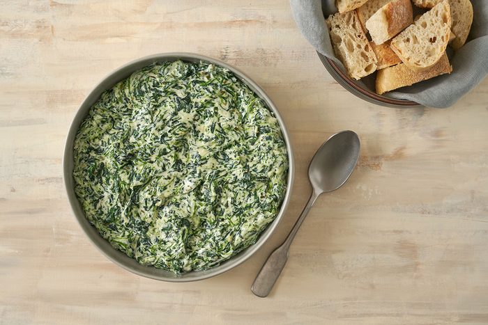 An overhead view of Creamed Spinach with Cream Cheese, warm and creamy, served in a dish, by Taste of Home.