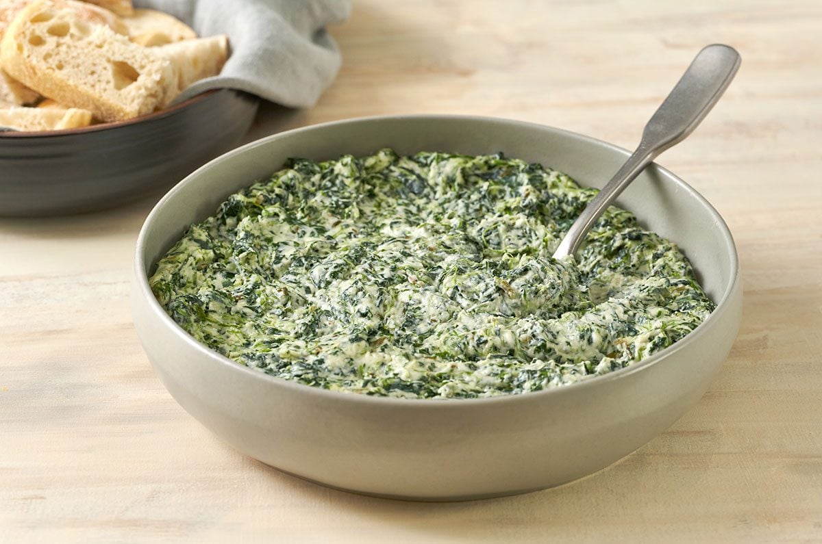 A close-up shot of Creamed Spinach with Cream Cheese, highlighting the smooth, creamy texture of the spinach blend, by Taste of Home.