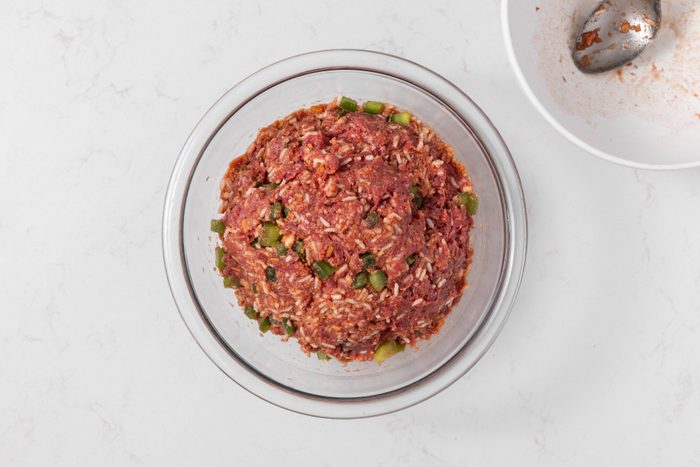 Crockpot cabbage rolls beef mixture and seasonings combined in mixing bowl.