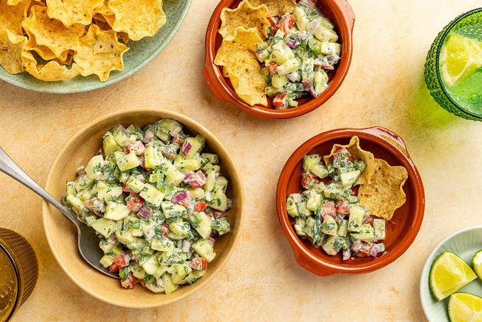 bowl with smaller side dishes filled with the salsa and chips.