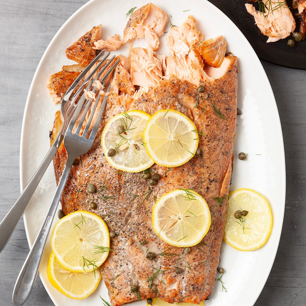 Full yield of Taste of Home Smoked Salmon garnished with lemon slices and capers