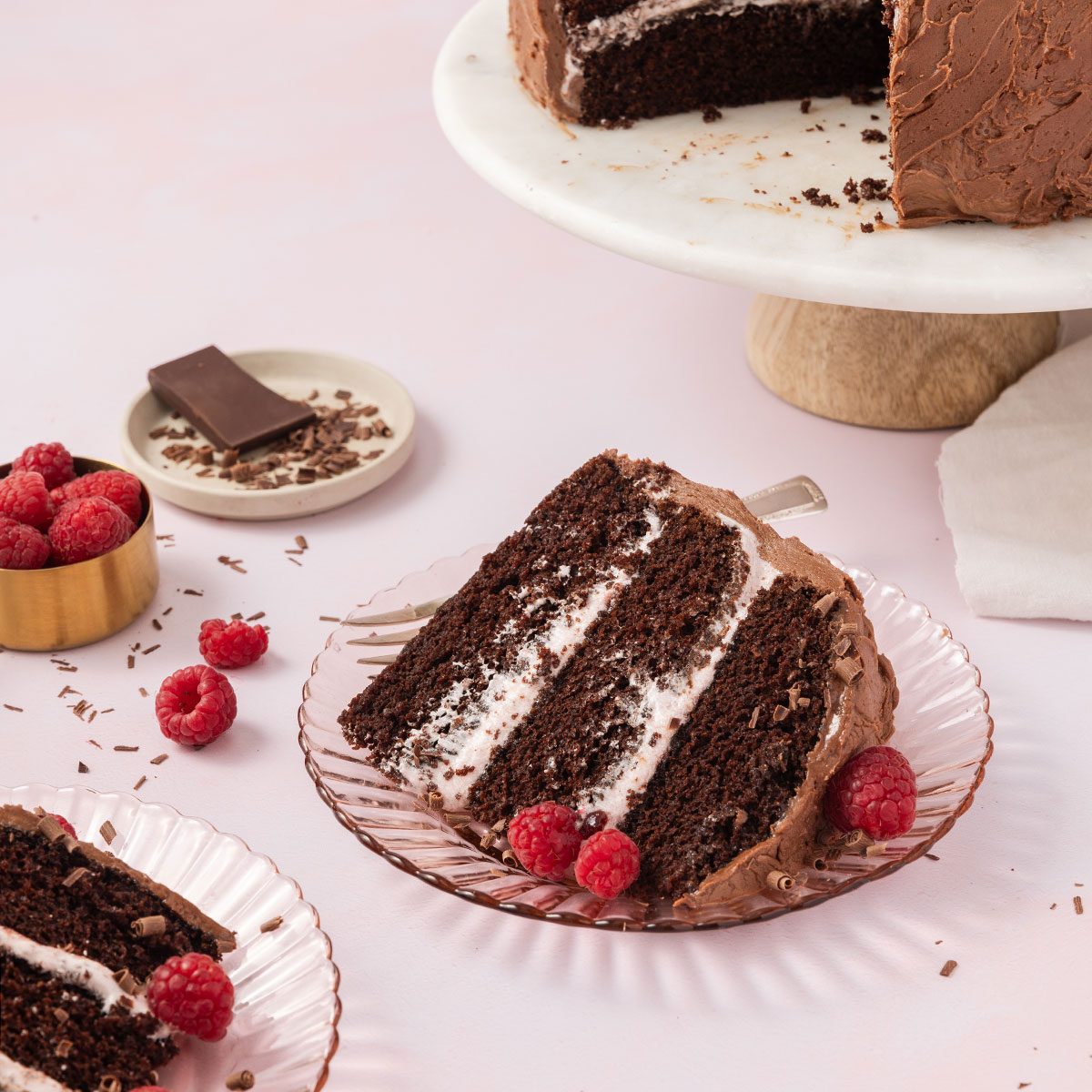 Chocolate raspberry cake sliced and served on plates.