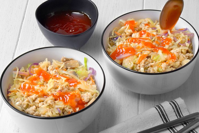 Two bowls of Egg Roll in a Bowl are showcased, The dish is topped with crispy fried wontons