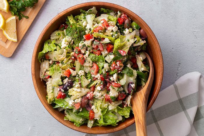 Overhead view of Greek Salad in a wooden serving bowl for Taste of Home
