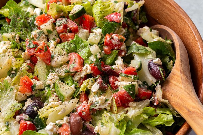 Close up of Greek Salad in a wooden serving bowl for Taste of Home