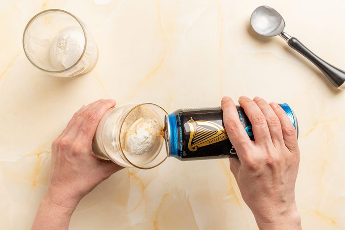 Taste of Home Guinness Float photo of pouring the stout into a vanilla ice cream filled pint glass.