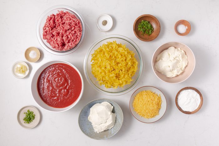 Ingredients for hamburger noodle casserole on kitchen counter.