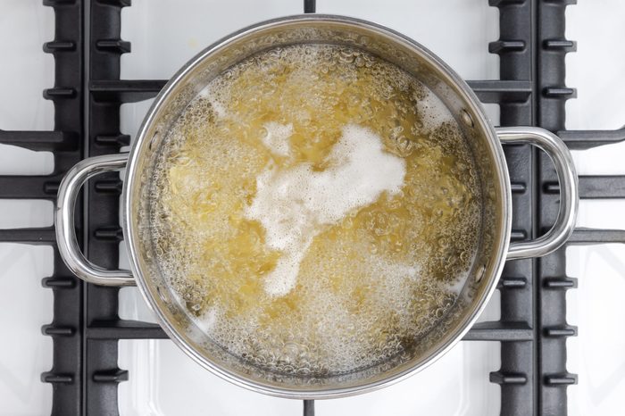 Egg noodles cooking in boiling water.