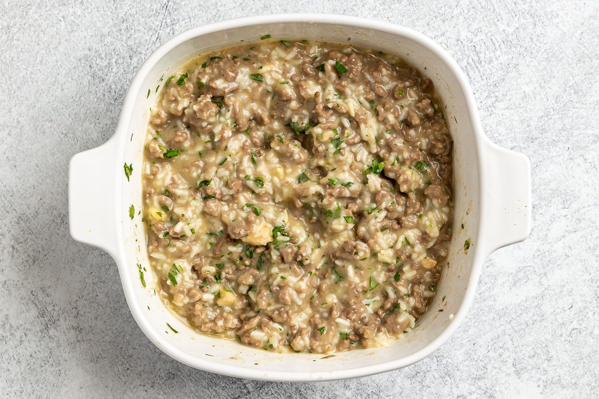 Taste of Home Hamburger and Rice Hot Dish photo of adding all the ingredients ot a 1.5 quart bakind dish.