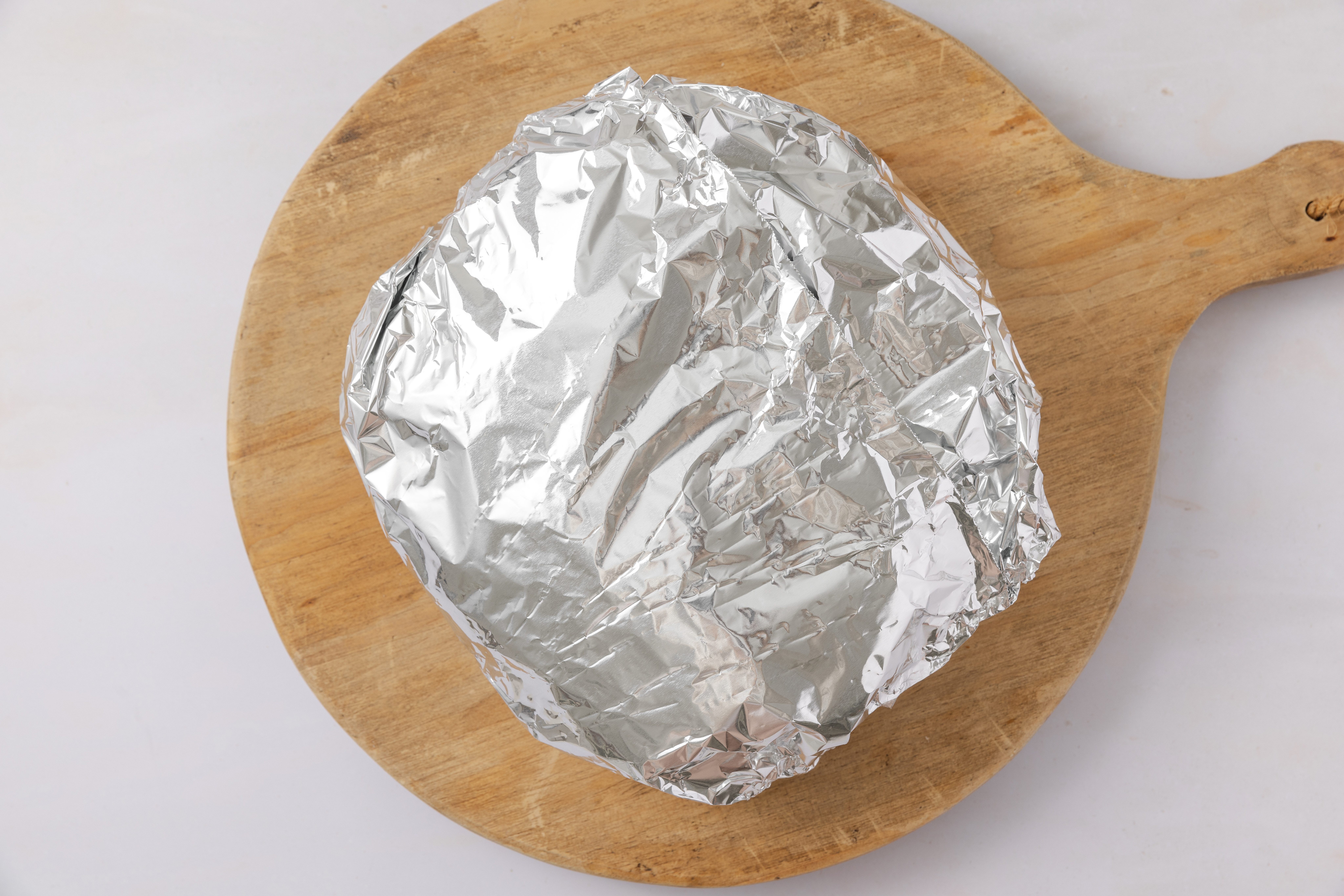 Hawaiian cheese bread wrapped in foil to go in the oven.