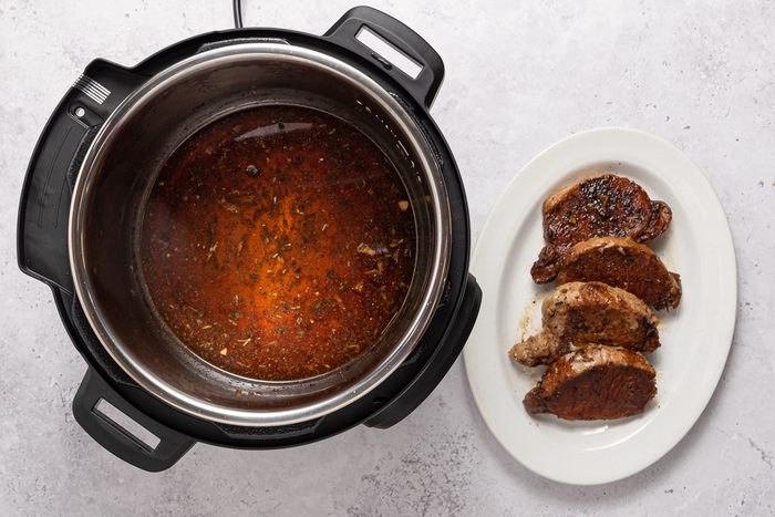 Instant Pot And Cooked Tenderloin On Serving Plate