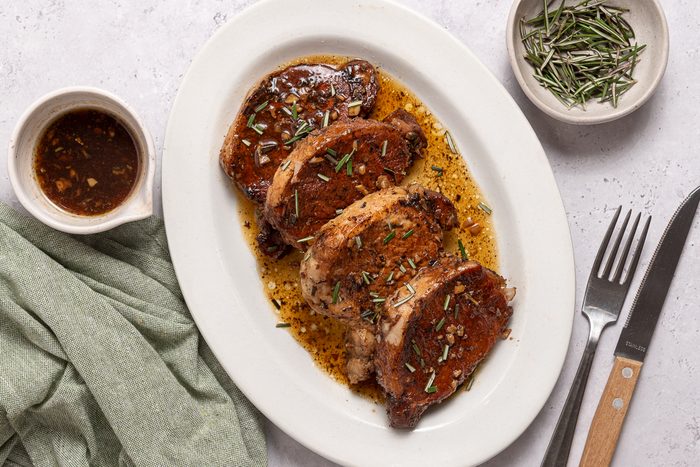 Instant Pot Pork Tenderloins On A Serving Plate With Sauce