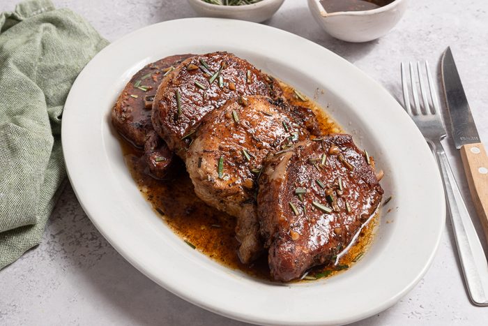 Instant Pot Pork Tenderloins On A Serving Plate With Sauce
