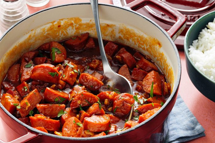 A bowl of Keilbasa served with white rice on a counter