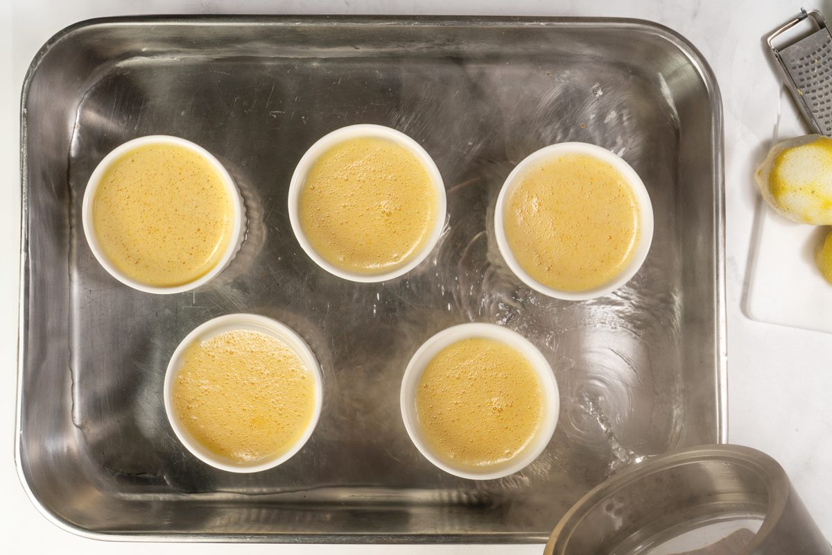Placing the Lemon Creme Brulée in the oven